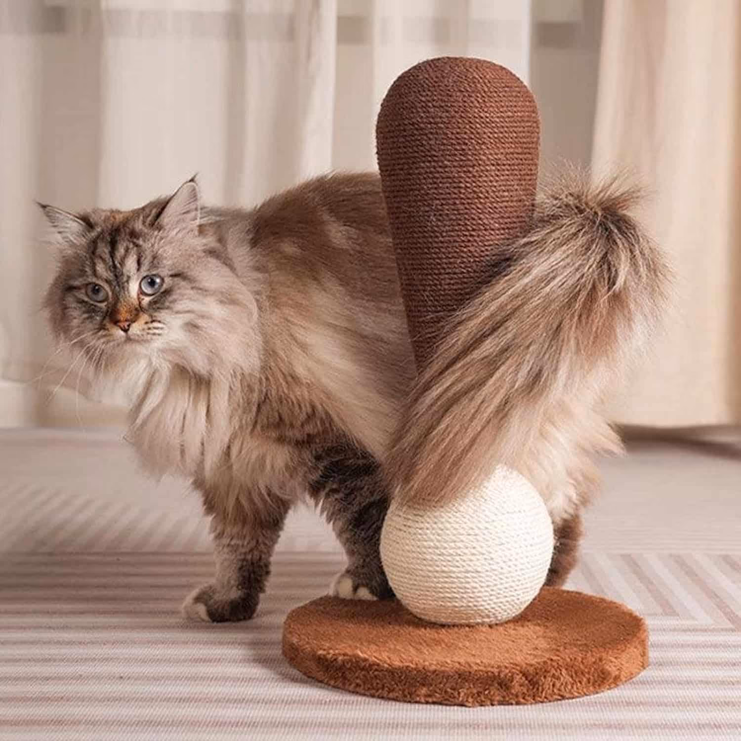 Cat scratching post with hand-woven sisal ball at base and tapered rope tower on thick plush pad