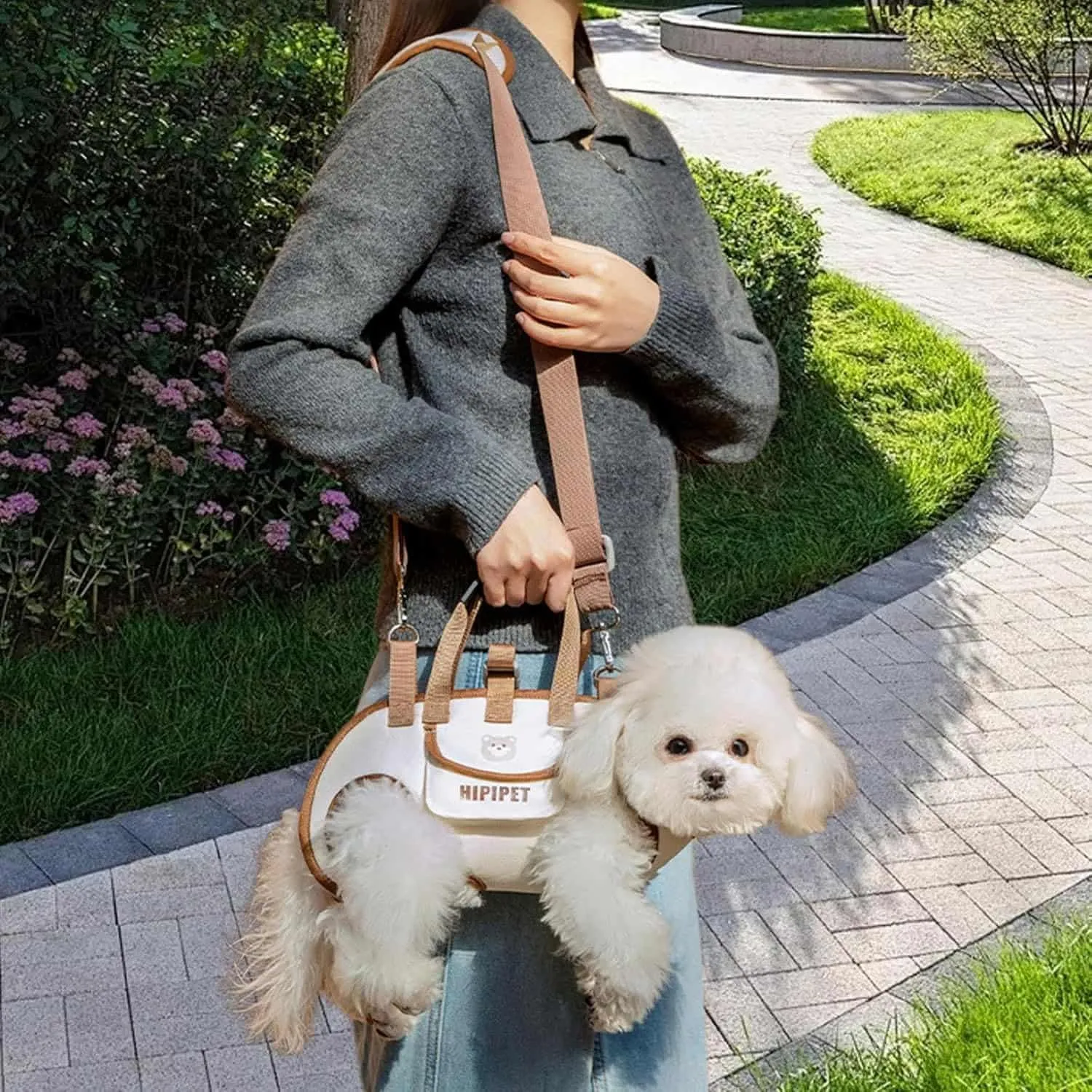 Beige and brown dog carrier bag with hand carry handle, shoulder strap, and leg openings for small dogs
